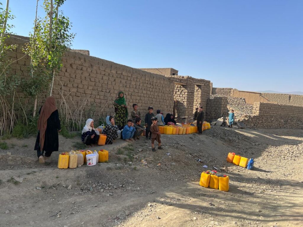 Women and children collecting water in rural Ghor