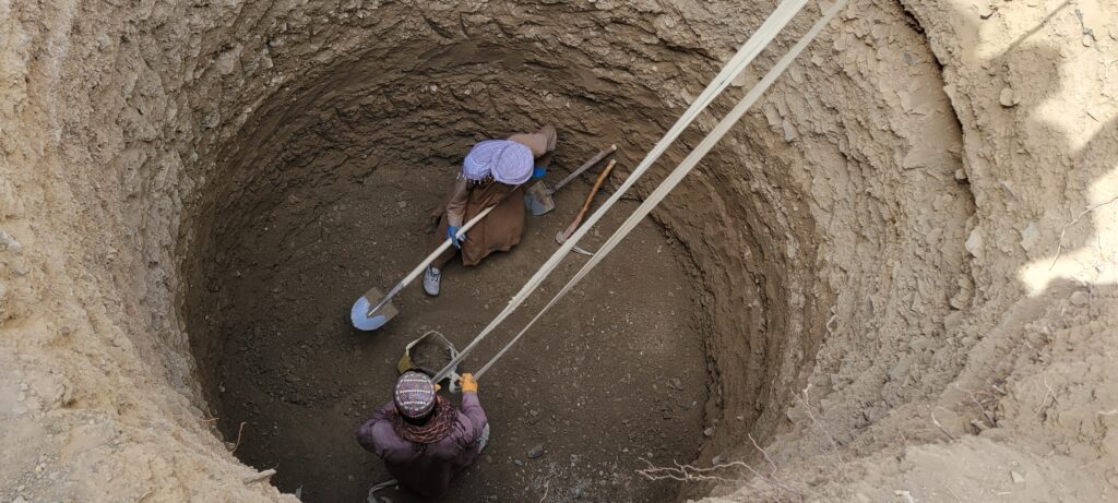 Workers hand-digging a water well in rural Ghor