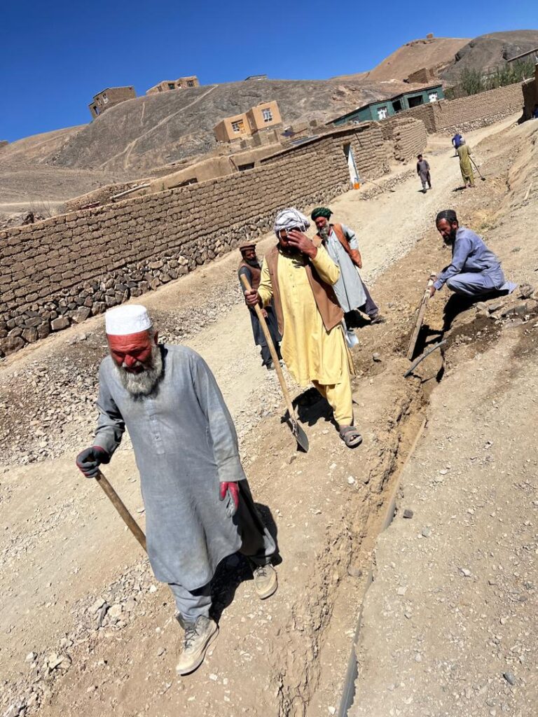 Villagers digging the water pipeline trench