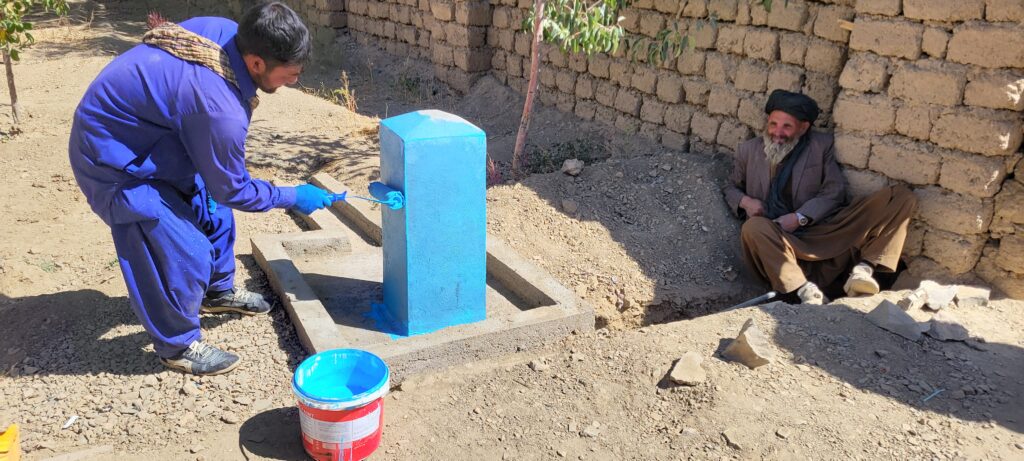A new blue water tap-stand being painted